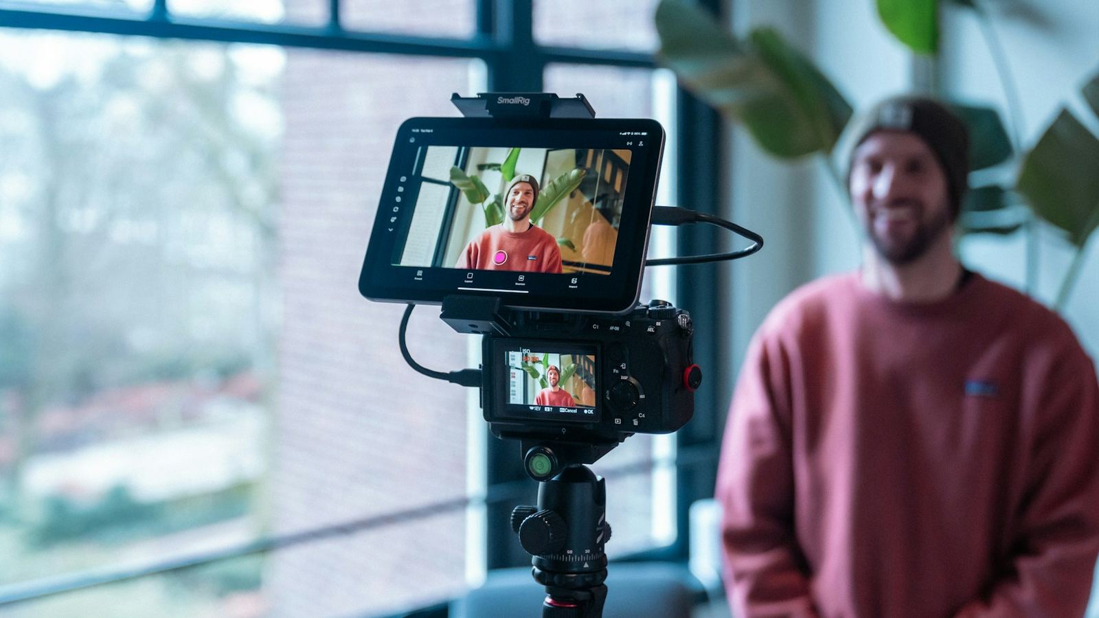 Creator recording himself with a camera and a flip-out monitor