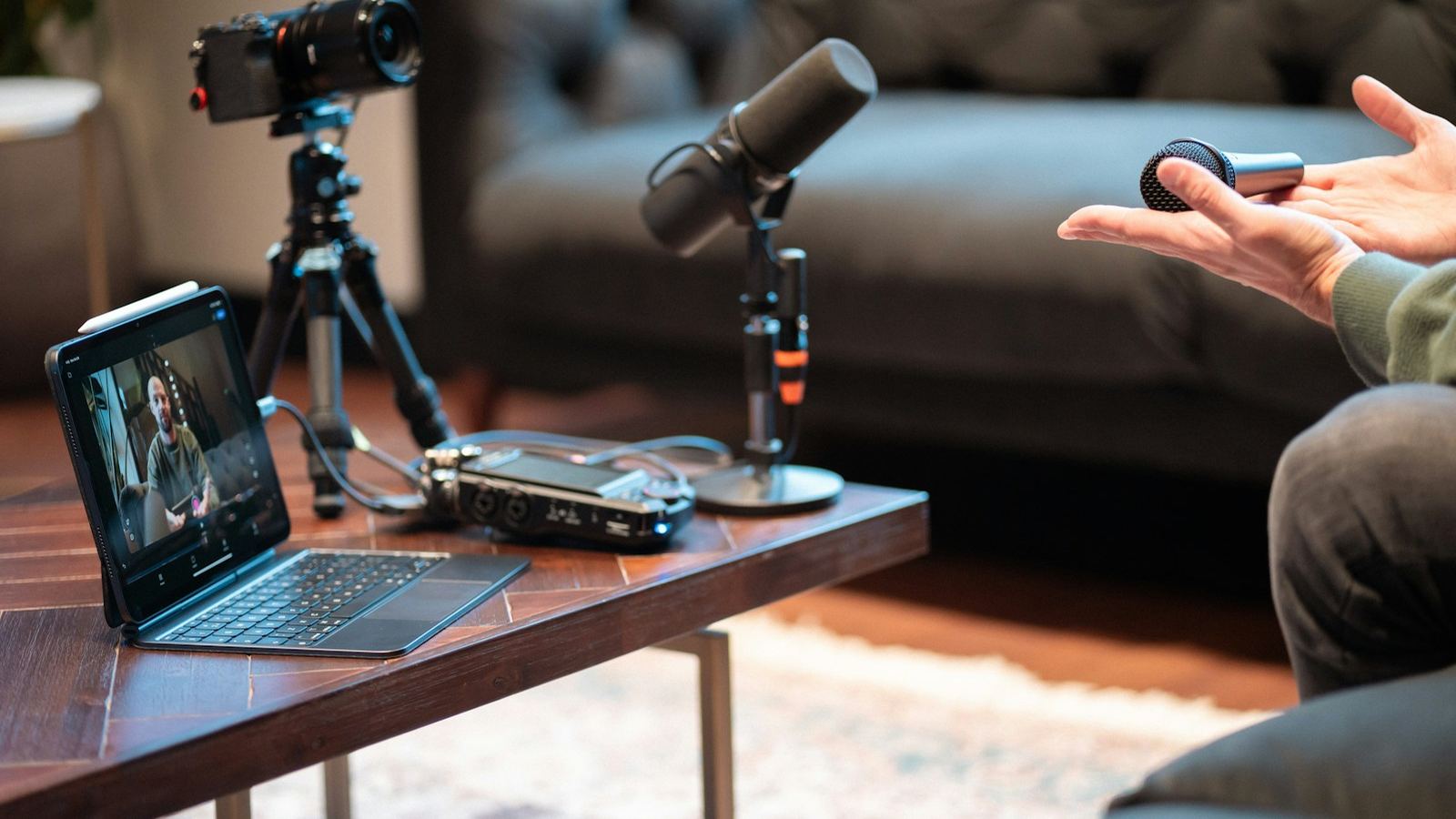 Podcast recording setup with a microphone, camera and laptop