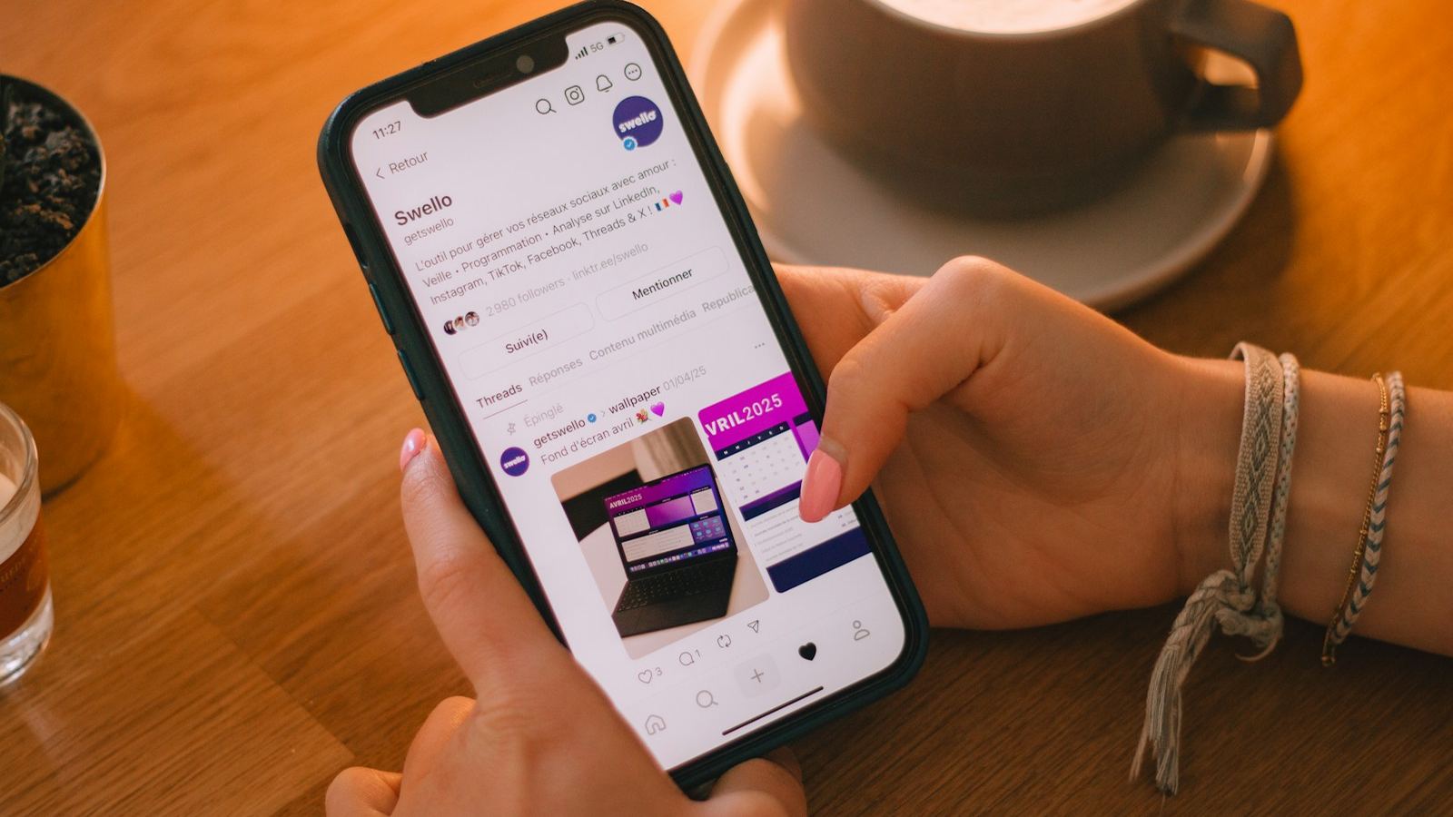 Hand scrolling a social media feed on a smartphone